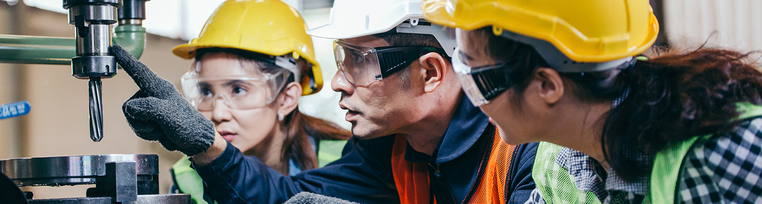 5 Tips for Picking the Best Training Record Management Online System 3 Workers Wearing PPE's and Discussing Machine Safety at a Workplace