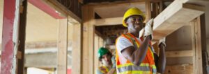 Tradesmen carrying lumber at construction site