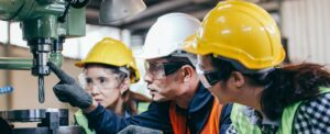 Asian male foreman manager showing case study of factory machine