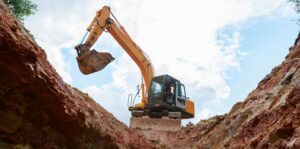 Excavator digging a trench. Work on the construction site.