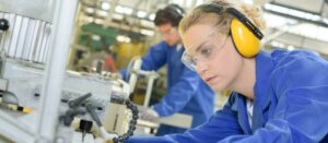 Woman using industrial machine