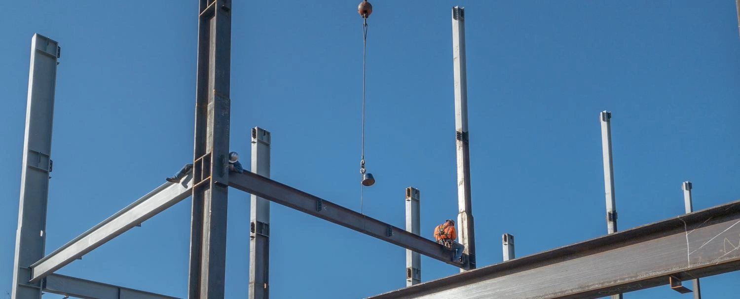 - BIS Safety Software Canada 2 ironworkers are on a horizontal steel I-beam just put into pla